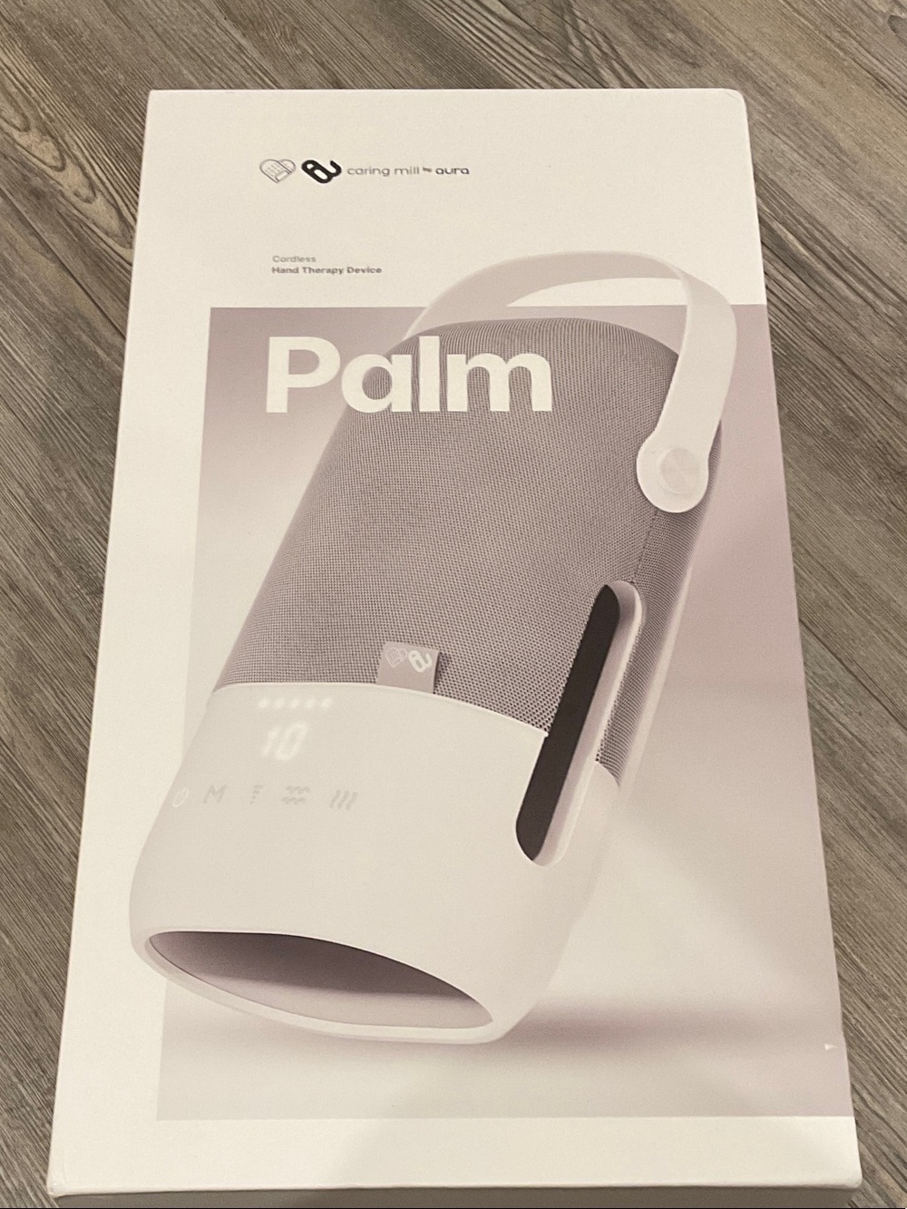 Aura Palm Cordless Hand Therapy Device in White and Light Gray